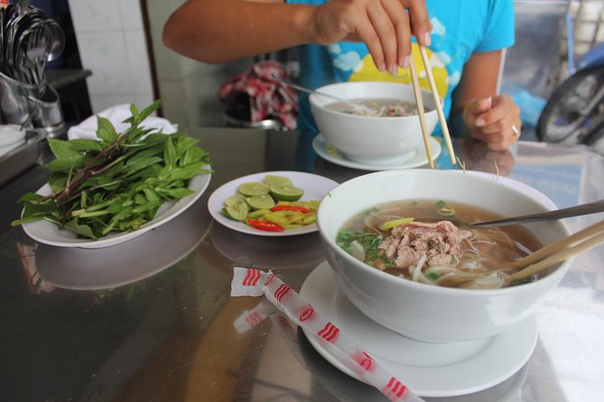 Small-group Street Food Lover by Motorbike (04 hours) - Riding pillion through the city